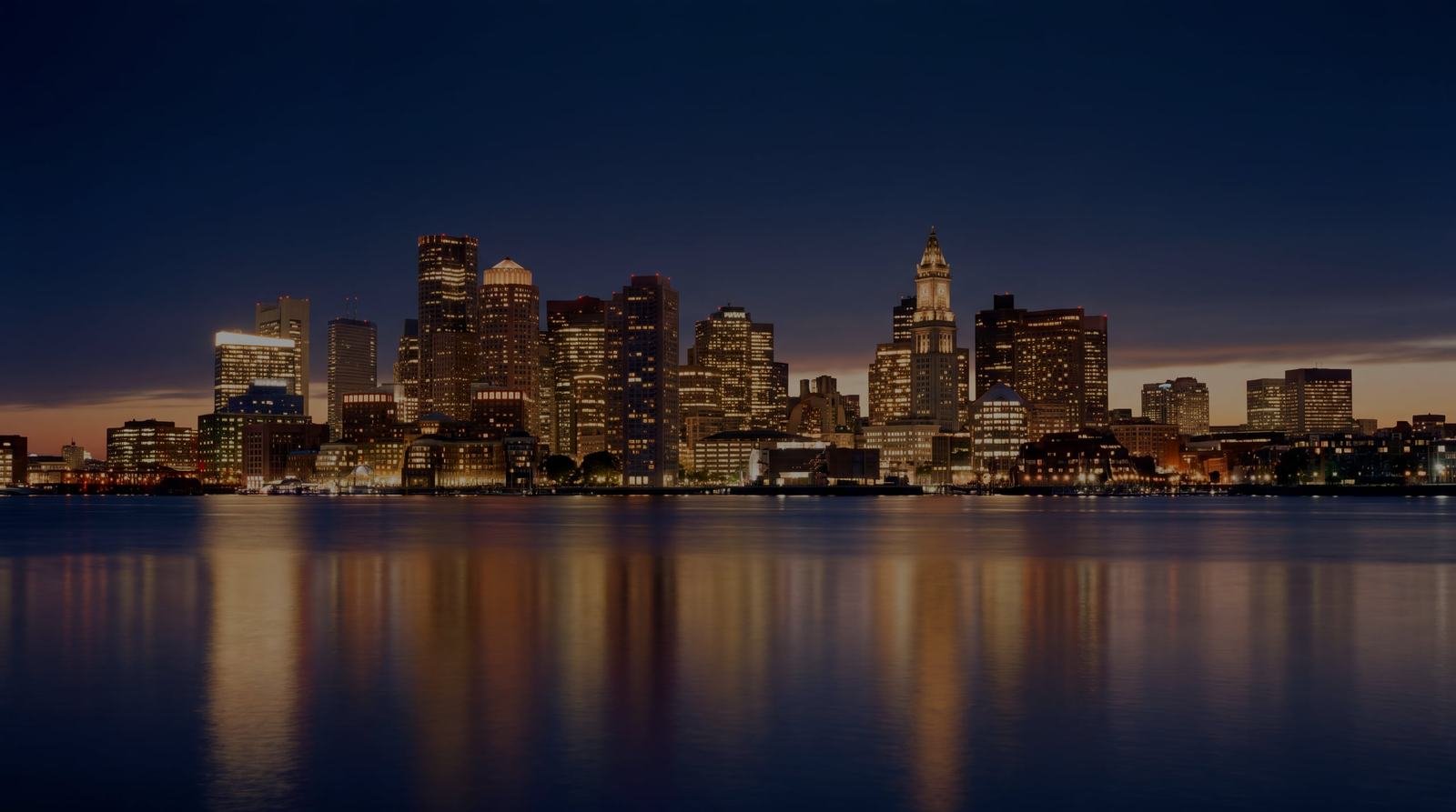 The Boston skyline across the harbor at dusk